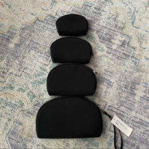Set of 4 cosmetic bags in black with zippers